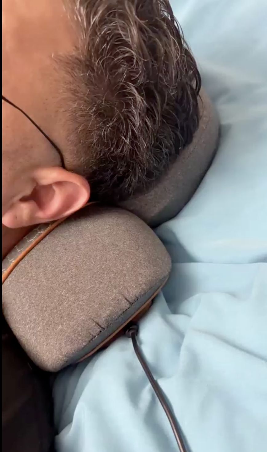 Customer photo - resting on the SpineSway Quad Fusion Neck Massager
